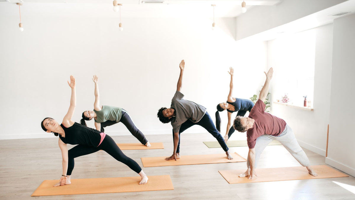 Group of people practicing yoga in a bright studio